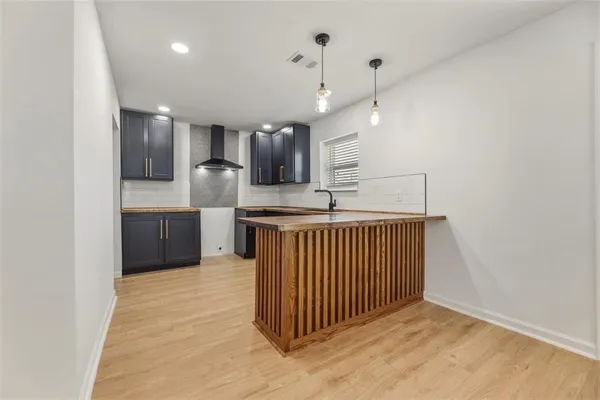 a kitchen with kitchen island a sink stainless steel appliances and cabinets