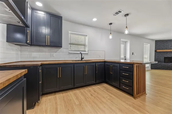 a kitchen with a sink and wooden cabinets