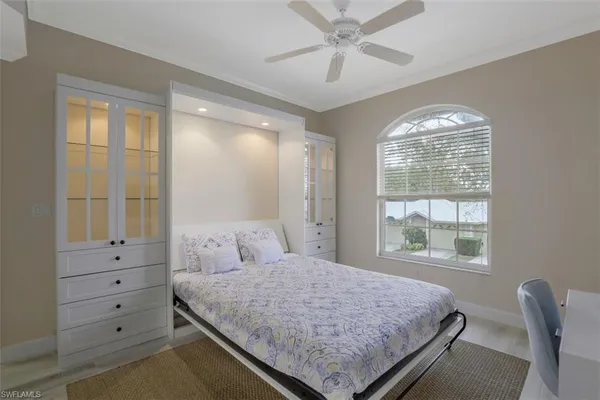 a bedroom with a large bed and a window