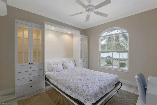 a bedroom with a large bed and a window