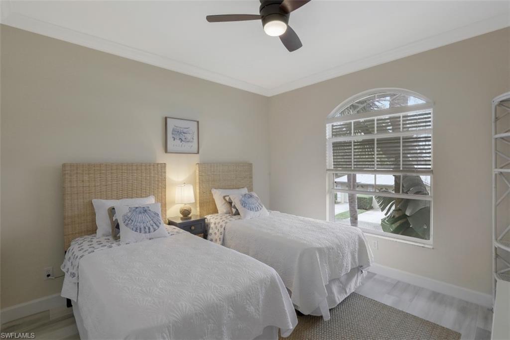 1240 Shady Rest Lane, Unit 102 Naples, FL 34103 - Photo 18 of 23 a bedroom with two beds and a window