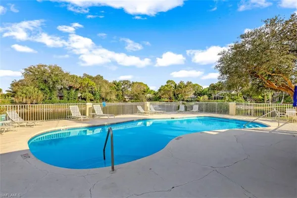 a view of a swimming pool with an outdoor space and seating area
