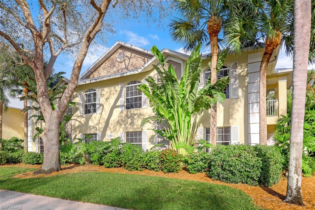 1240 Shady Rest Lane, Unit 102 Naples, FL 34103 - Photo 23 of 23 a front view of a house with a garden