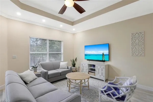 a living room with furniture a rug and a flat screen tv