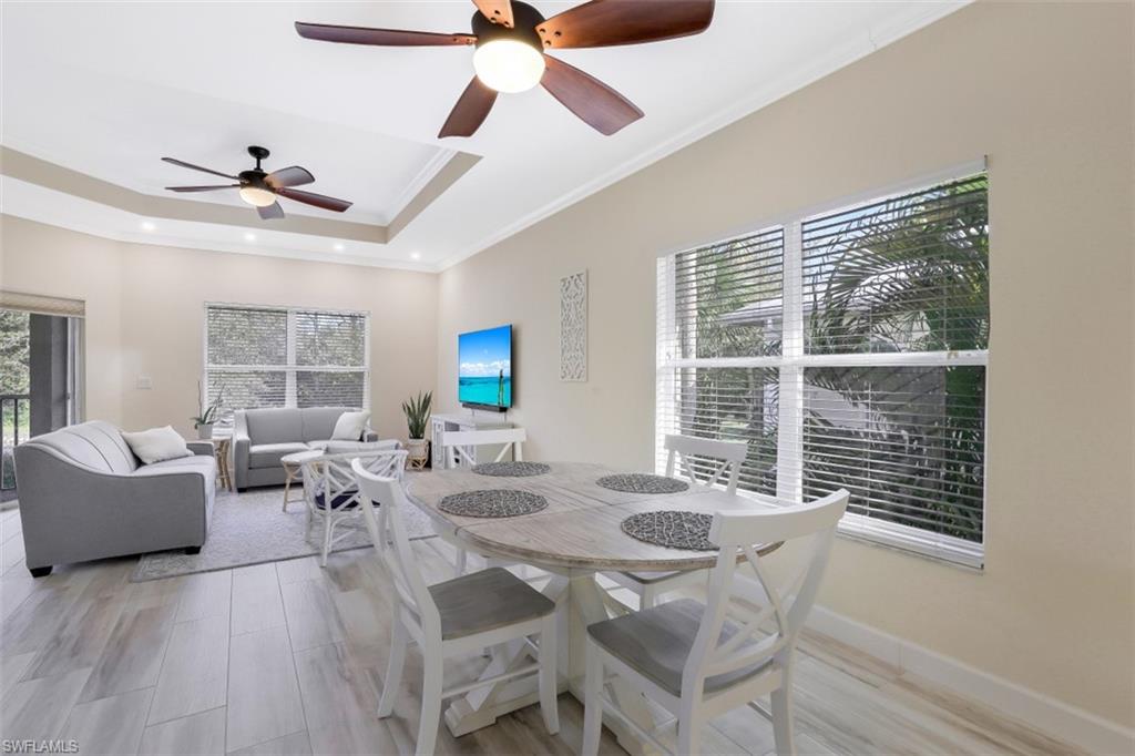 1240 Shady Rest Lane, Unit 102 Naples, FL 34103 - Photo 7 of 23 a living room with furniture and a window