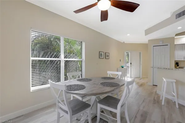 a view of a dining room with furniture and wooden floor