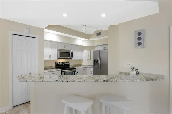 a view of living room with granite countertop furniture and fireplace