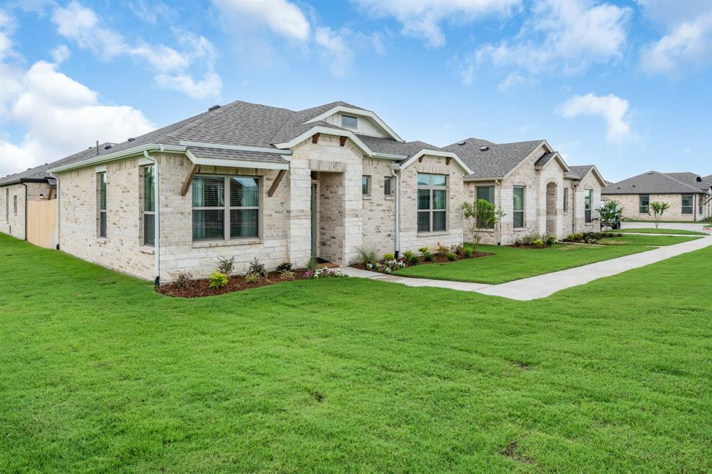 6415 Fm 1570 Street West, Unit 116 Greenville, TX 75402 - Photo 1 of 34 a front view of a house with a garden