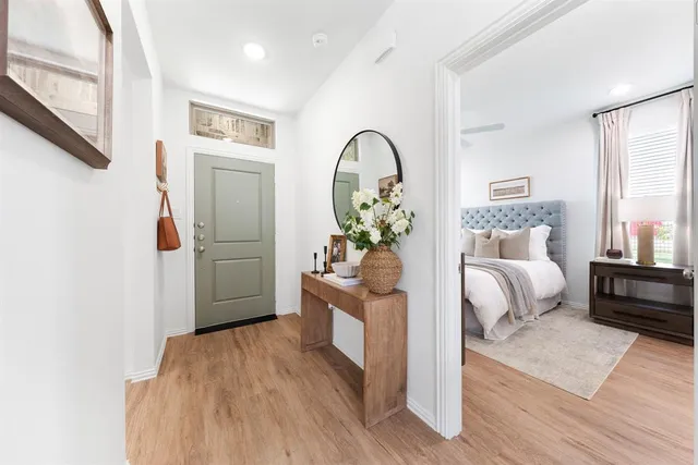 a bedroom with furniture and wooden floor