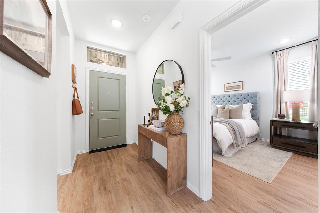 6415 Fm 1570 Street West, Unit 116 Greenville, TX 75402 - Photo 11 of 34 a bedroom with furniture and wooden floor