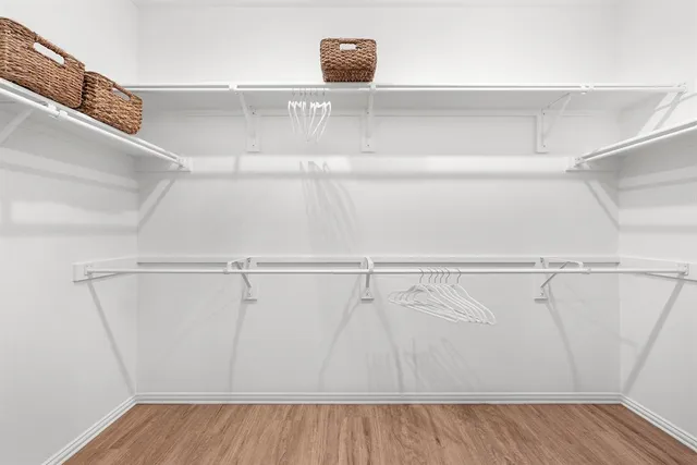 a view of walk in closet with empty racks