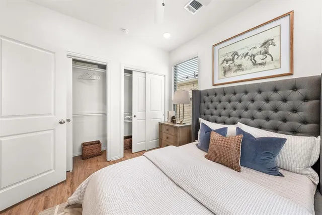 a bedroom with a bed and a painting on the wall