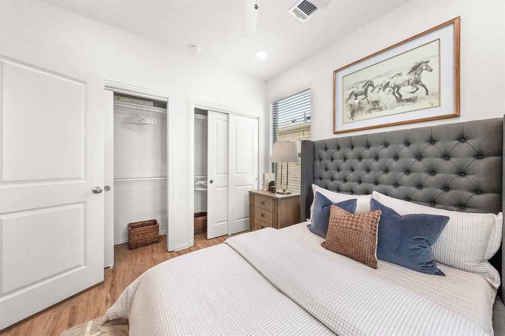 6415 Fm 1570 Street West, Unit 116 Greenville, TX 75402 - Photo 28 of 34 a bedroom with a bed and a painting on the wall