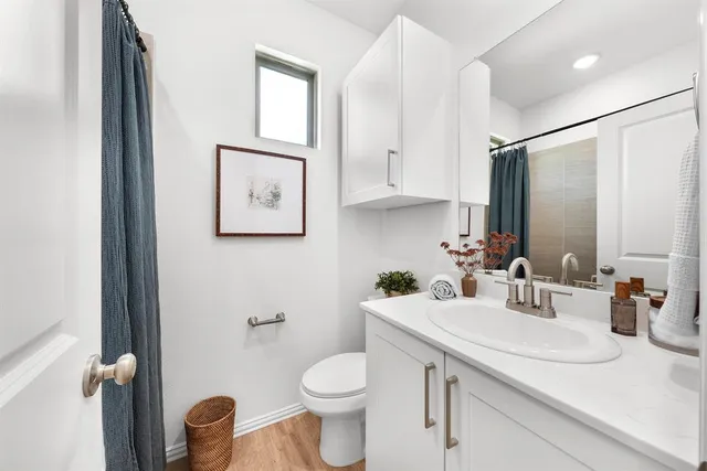 a bathroom with a toilet sink and mirror