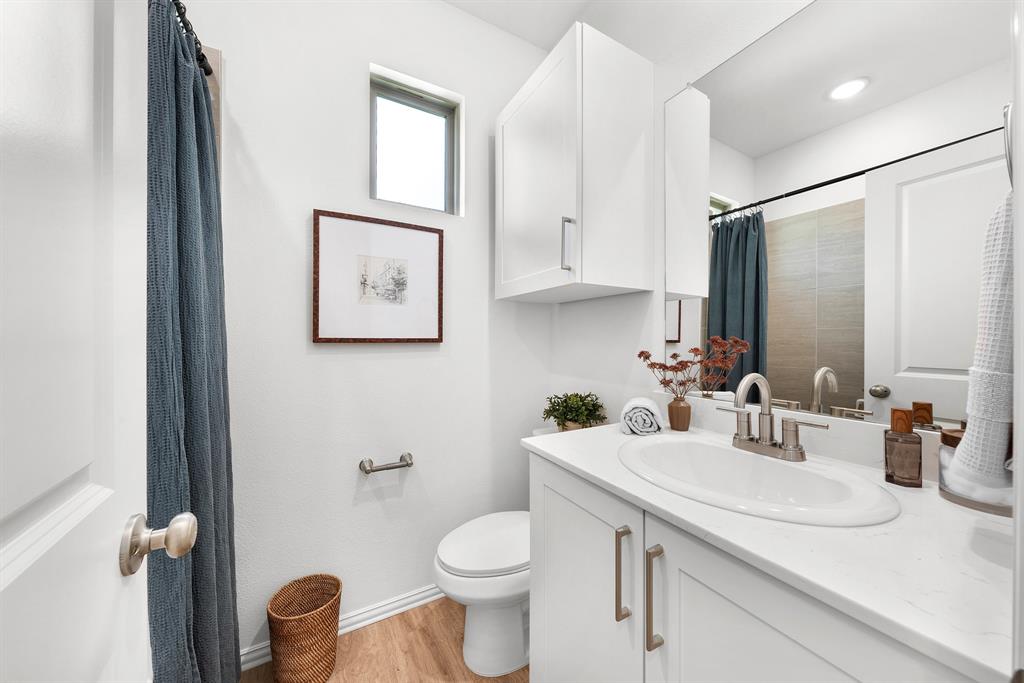 6415 Fm 1570 Street West, Unit 116 Greenville, TX 75402 - Photo 29 of 34 a bathroom with a toilet sink and mirror