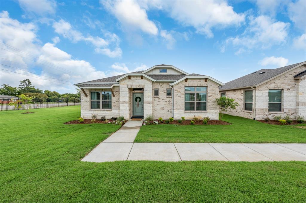 6415 Fm 1570 Street West, Unit 116 Greenville, TX 75402 - Photo 3 of 34 a front view of a house with a garden
