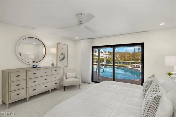 a bedroom with a bed and a potted plant