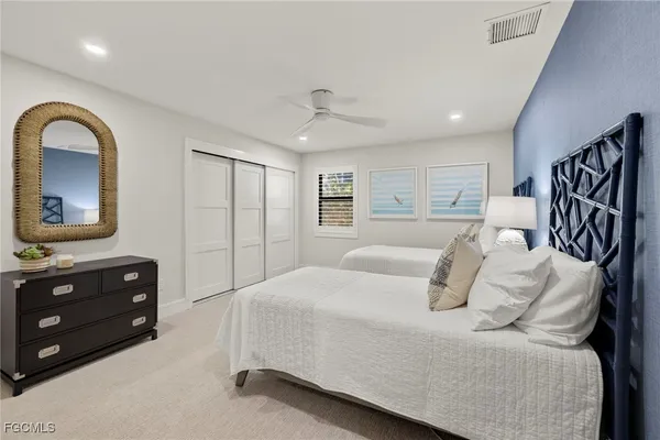 a bedroom with a bed a lamp and window