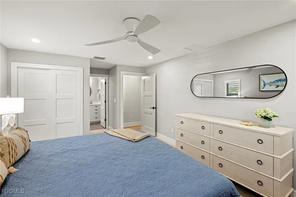 a en suite bathroom with a toilet a sink and a mirror