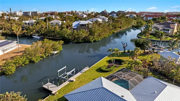 an aerial view of a house with swimming pool and lake view