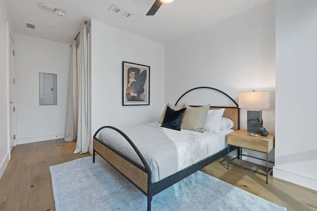 a bedroom with bed and a potted plant