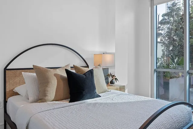 a bed room with a bed and a painting