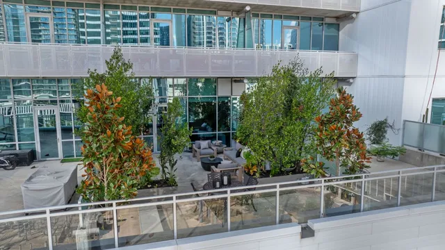 front view of house with large window and potted plants