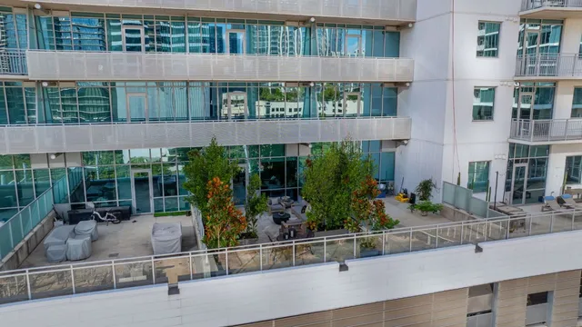 a view of building with yard and sitting area