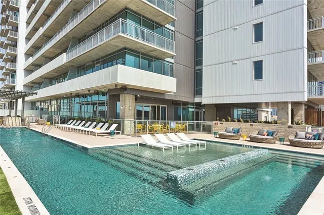 a swimming pool with outdoor seating and yard