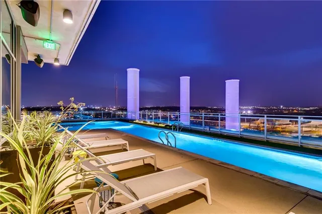 a swimming pool with outdoor seating and yard