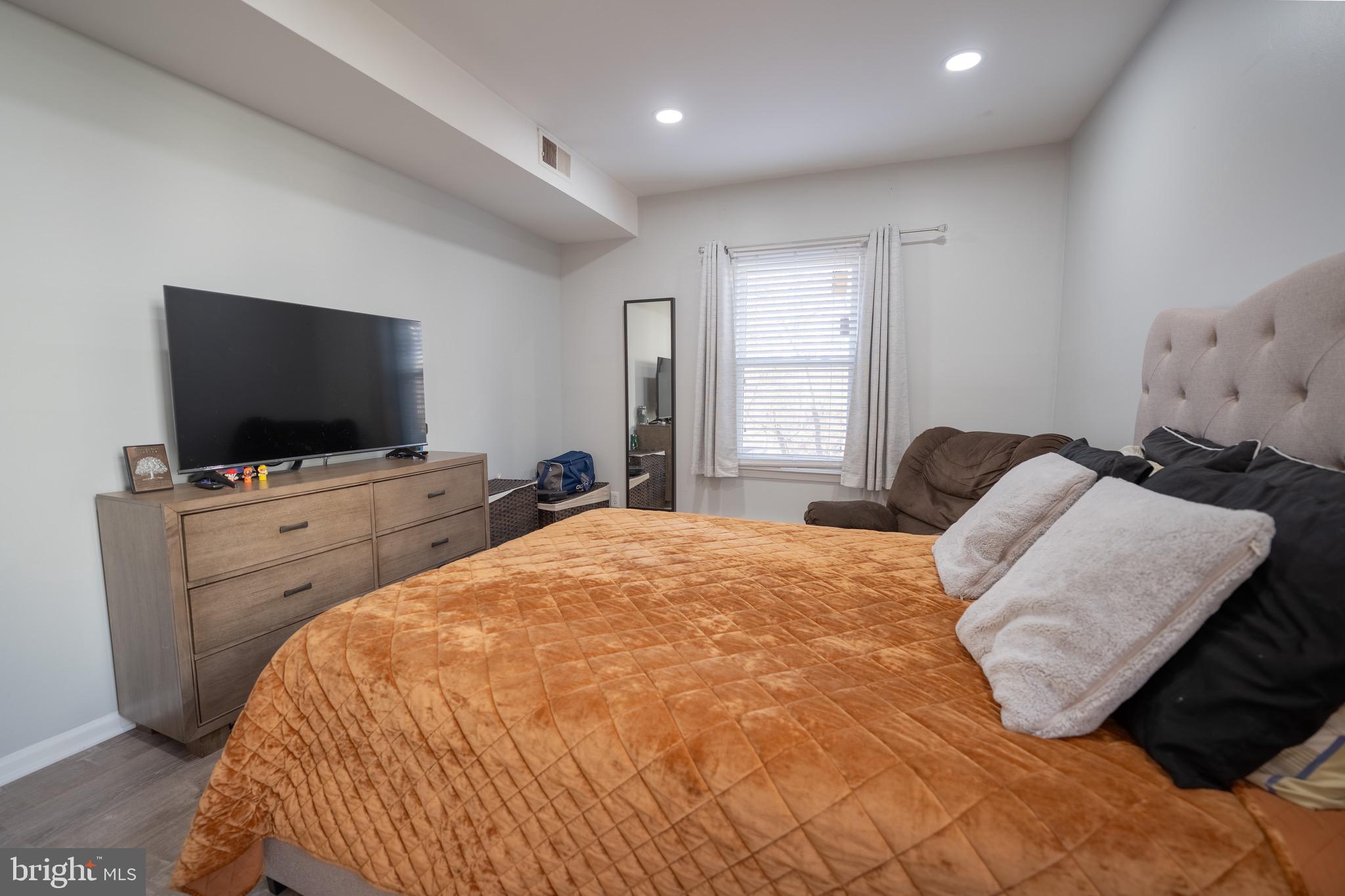 15 Pickering Court, Unit 1502 Germantown, MD 20874 - Photo 11 of 17 a bedroom with a bed and a flat screen tv