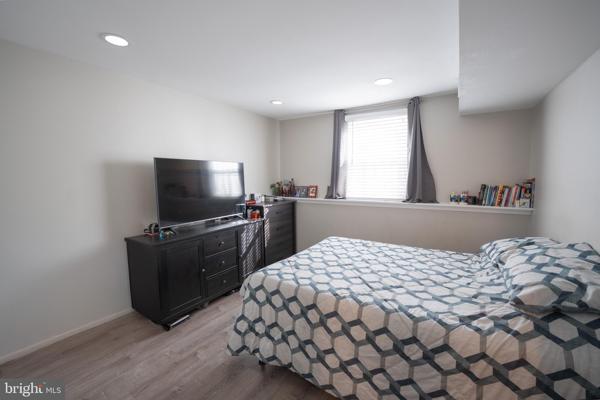 15 Pickering Court, Unit 1502 Germantown, MD 20874 - Photo 15 of 17 a bedroom with a bed and a flat screen tv