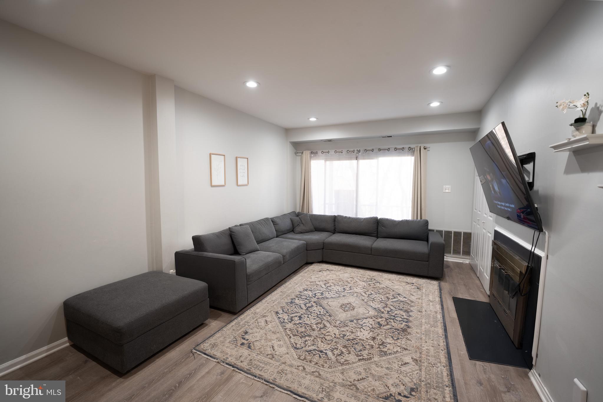 15 Pickering Court, Unit 1502 Germantown, MD 20874 - Photo 2 of 17 a living room with furniture window and a fireplace