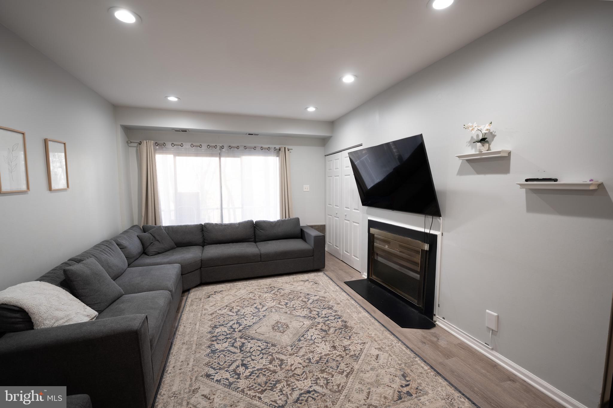 15 Pickering Court, Unit 1502 Germantown, MD 20874 - Photo 5 of 17 a living room with furniture and a flat screen tv