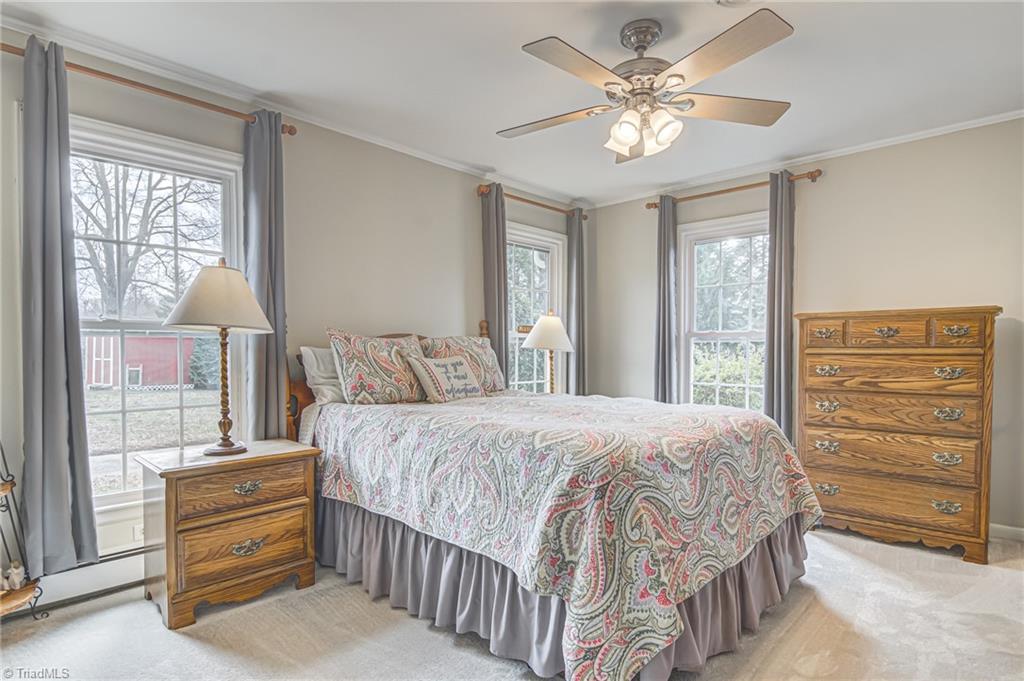 305 Pine Ridge Drive High Point, NC 27262 - Photo 15 of 35 Wonderful primary bedroom feature large windows that let in plenty of natural lights, ceiling fan, and crown moulding.
