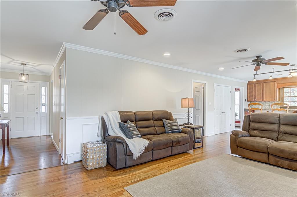 305 Pine Ridge Drive High Point, NC 27262 - Photo 4 of 35 Den features ceiling fan, recessed lights, chair rail panel moulding, and wood flooring!
