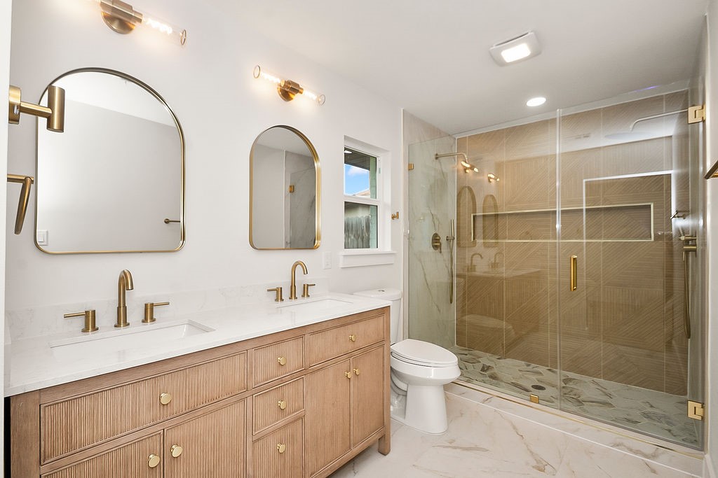 6106 Rutherglenn Drive Houston, TX 77096 - Photo 21 of 41 Luxurious spa-inspired primary bathroom with dual vanities, designer finishes, and oversized walk-in shower.