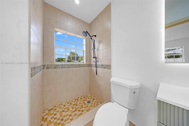 a white toilet sitting next to a bathroom sink