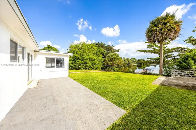 a view of house with outdoor space and swimming pool
