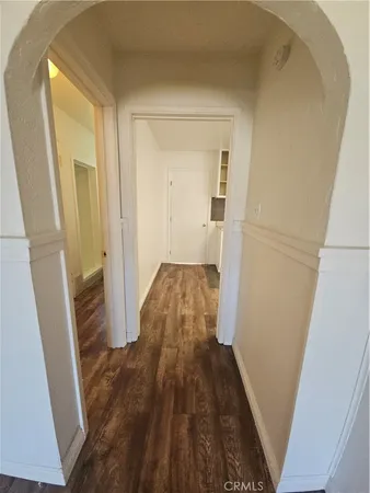 a view of a hallway and wooden floor