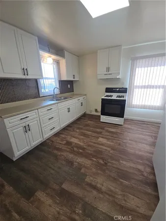 a kitchen with stainless steel appliances a refrigerator sink and cabinets