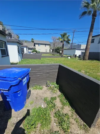 a view of a backyard with potted plants