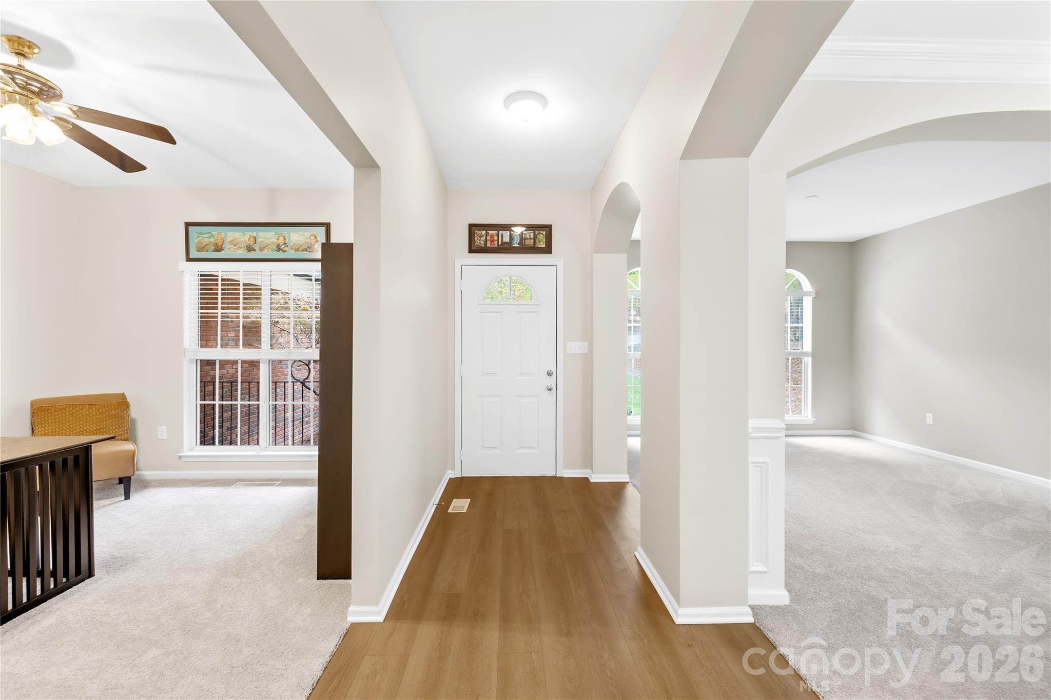 11113 Asbury Chapel Road Huntersville, NC 28078 - Photo 7 of 43 a view of a hallway with wooden floor and a living room