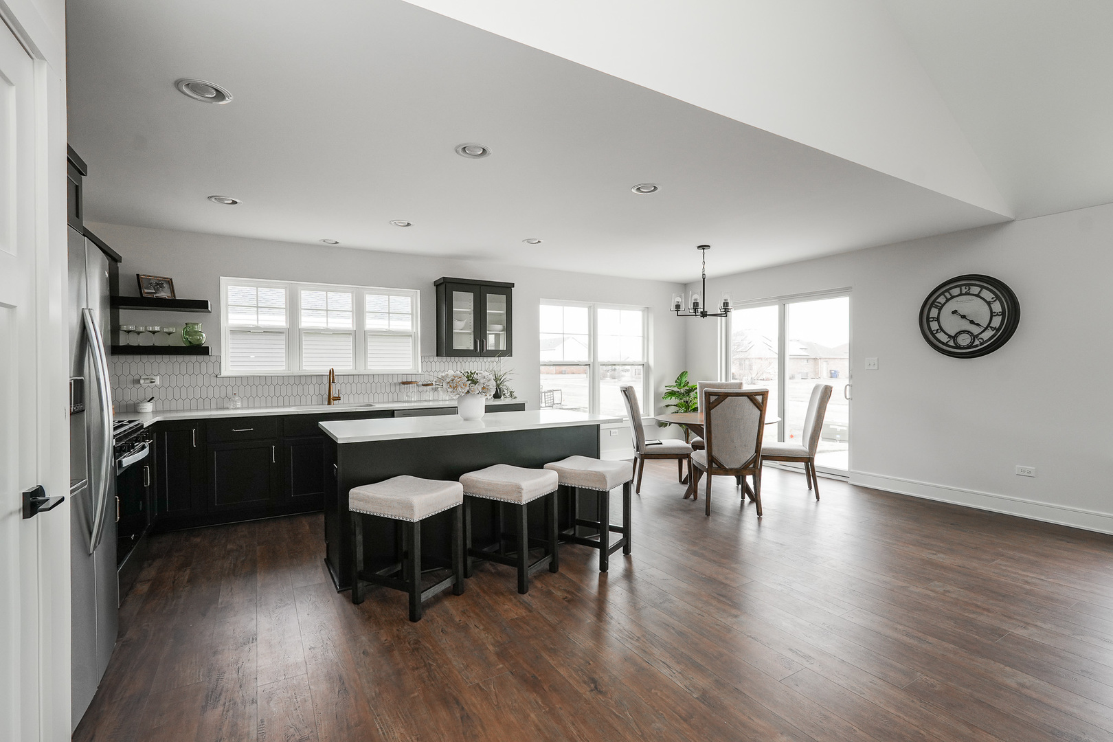 1009 Spring Street Manteno, IL 60950 - Photo 19 of 36 a living room with stainless steel appliances granite countertop furniture wooden floor and a kitchen view