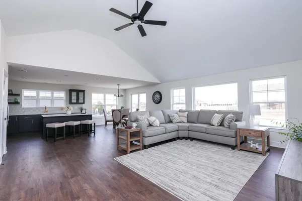 a living room with furniture and a wooden floor