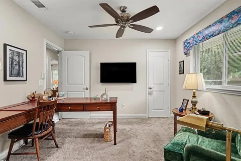 a living room with furniture a flat screen tv and a large window