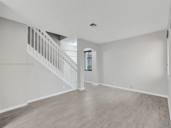 a view of an entryway with wooden floor
