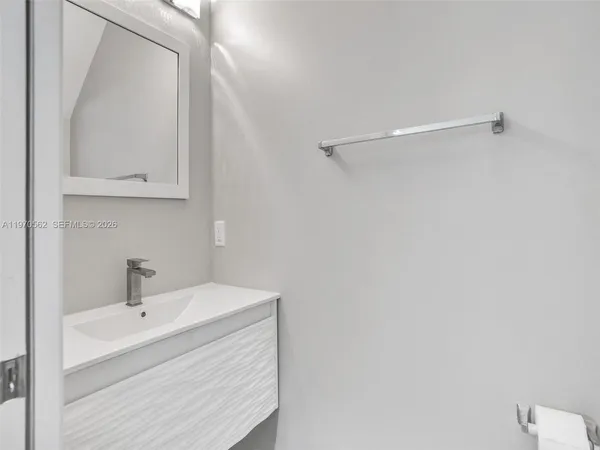 a bathroom with a sink a mirror and vanity