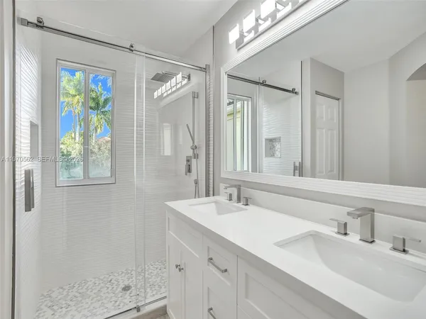 a bathroom with a sink double vanity and a mirror