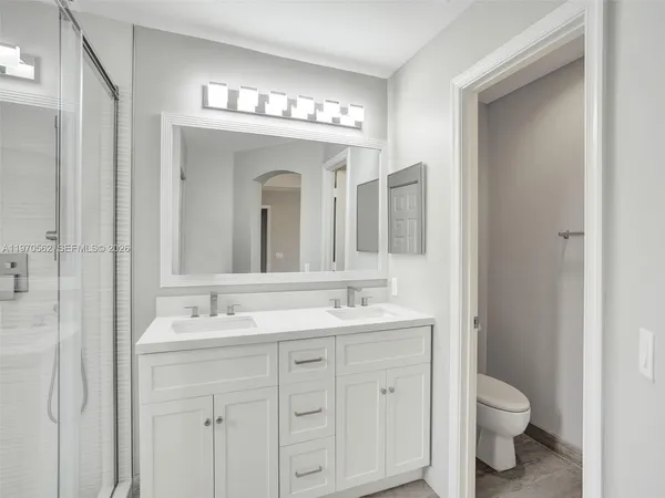a bathroom with a double vanity sink and a mirror